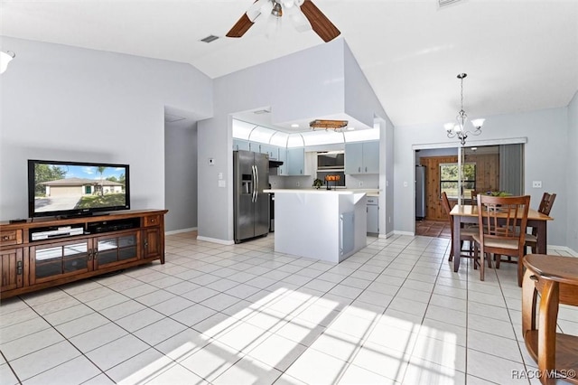 kitchen with light tile patterned flooring, stainless steel fridge with ice dispenser, light countertops, ceiling fan with notable chandelier, and visible vents