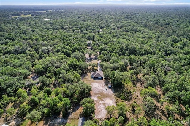 drone / aerial view with a wooded view