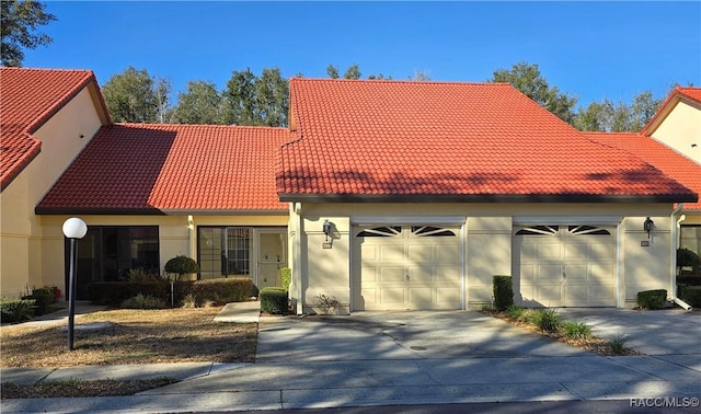 mediterranean / spanish home featuring a garage