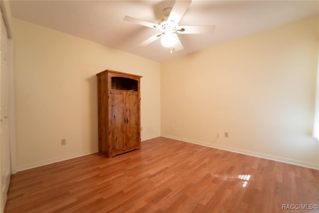 unfurnished bedroom with ceiling fan and light hardwood / wood-style flooring