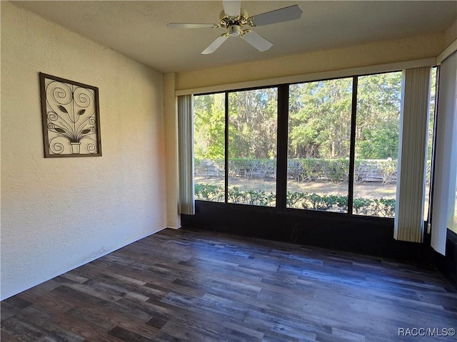 spare room with ceiling fan and dark hardwood / wood-style floors