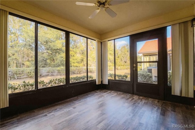 unfurnished sunroom with plenty of natural light and ceiling fan