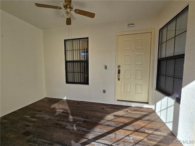 interior space featuring wood-type flooring and ceiling fan