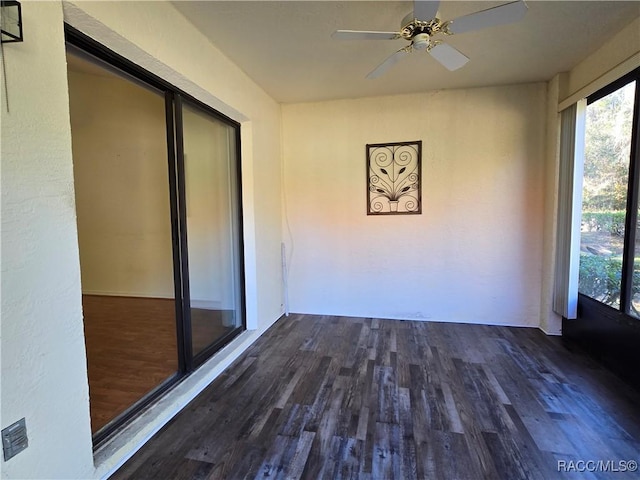 unfurnished sunroom featuring ceiling fan