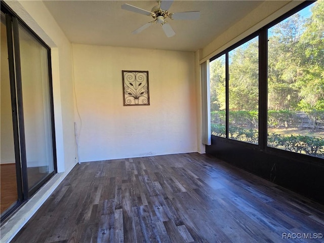 unfurnished sunroom featuring ceiling fan