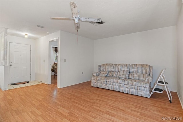 living room featuring ceiling fan and light hardwood / wood-style floors