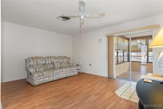 living room with ceiling fan and hardwood / wood-style flooring