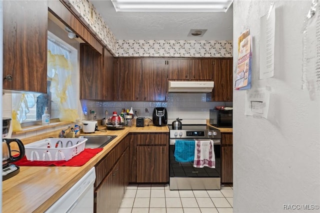 kitchen featuring dark brown cabinetry, a textured ceiling, light tile patterned floors, and stainless steel electric stove