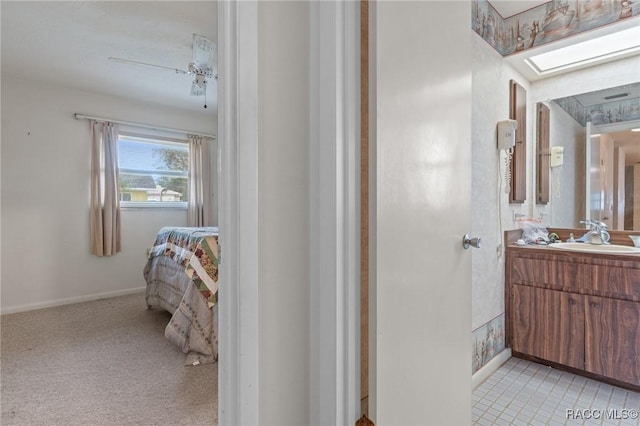 bathroom featuring vanity and a skylight