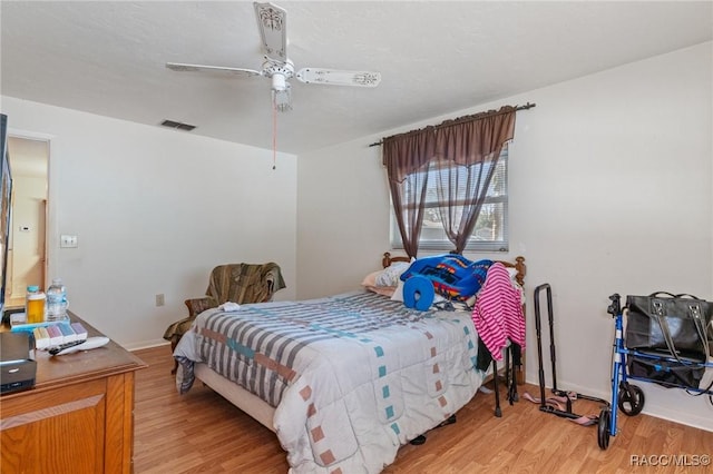 bedroom with ceiling fan and light hardwood / wood-style flooring