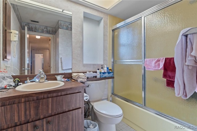 full bathroom with shower / bath combination with glass door, vanity, and toilet