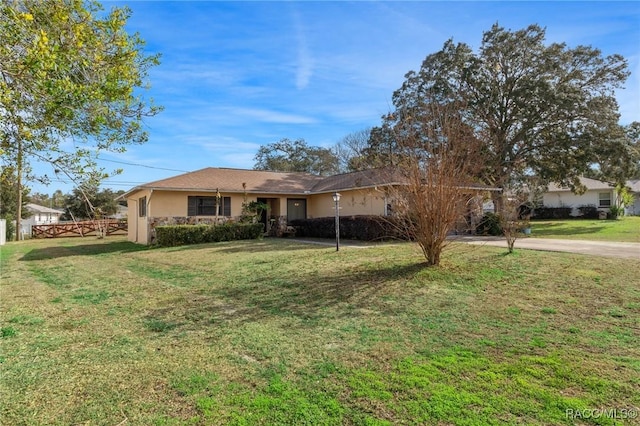 ranch-style home featuring a front yard