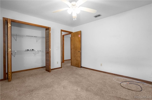 unfurnished bedroom with light carpet, a closet, and ceiling fan