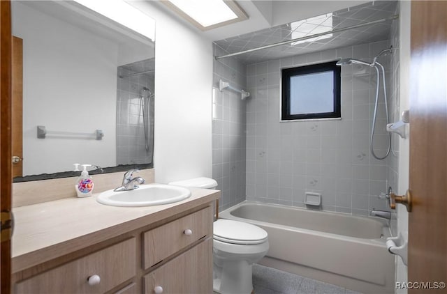 full bathroom with vanity, tiled shower / bath, and toilet