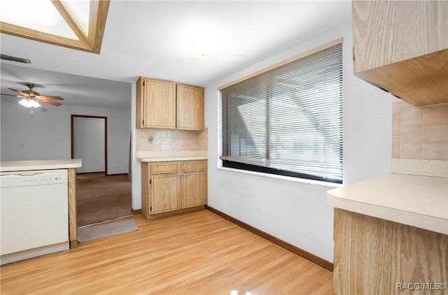 kitchen featuring light brown cabinetry, dishwasher, ceiling fan, decorative backsplash, and light wood-type flooring