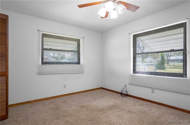 unfurnished room with light carpet and ceiling fan