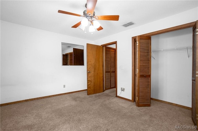 unfurnished bedroom featuring ceiling fan, light colored carpet, and a closet