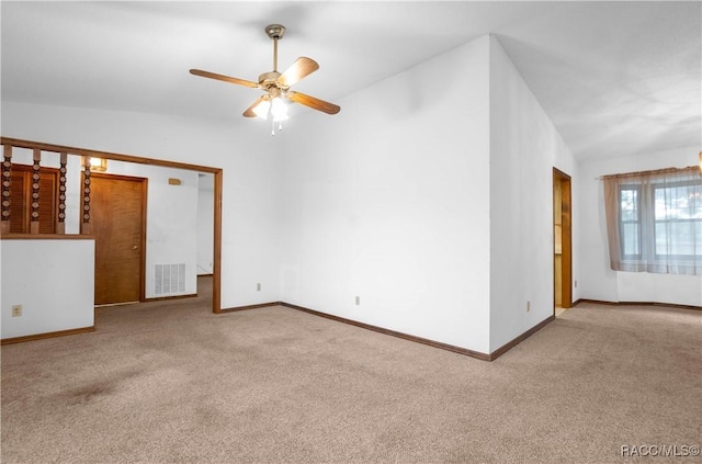 carpeted empty room with ceiling fan and lofted ceiling