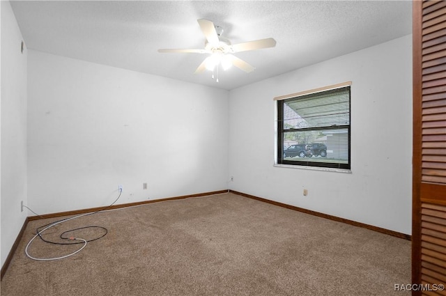 unfurnished room with ceiling fan, carpet flooring, and a textured ceiling