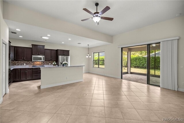 1825 W Caroline Path, Lecanto, FL 34461 - kitchen featuring appliances with stainless steel finishes, a ceiling fan, backsplash, dark brown cabinets, and light tile patterned flooring