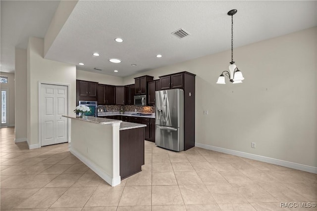 1825 W Caroline Path, Lecanto, FL 34461 - kitchen with appliances with stainless steel finishes, a chandelier, backsplash, light tile patterned floors, and a textured ceiling