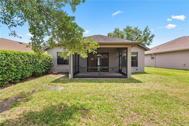 1825 W Caroline Path, Lecanto, FL 34461 - back of property featuring stucco siding, a sunroom, and a lawn