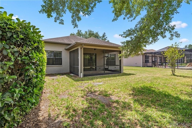 1825 W Caroline Path, Lecanto, FL 34461 - rear view of house with stucco siding, a yard, and a sunroom
