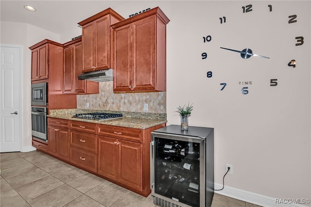 kitchen featuring wine cooler, light stone counters, under cabinet range hood, stainless steel appliances, and decorative backsplash