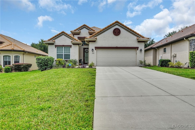 mediterranean / spanish home featuring a front lawn, driveway, a tiled roof, and an attached garage