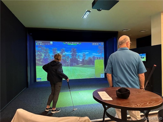 recreation room with golf simulator, visible vents, and carpet floors