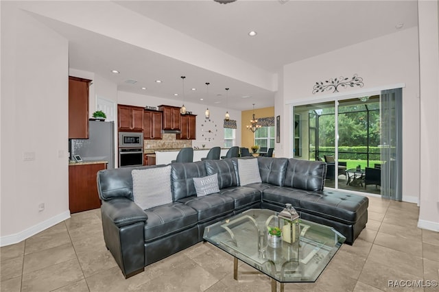 living room with recessed lighting, a notable chandelier, baseboards, and light tile patterned floors