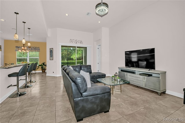 living room with visible vents, a chandelier, baseboards, and recessed lighting