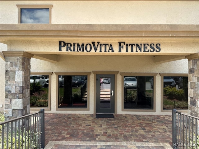 entrance to property featuring stucco siding