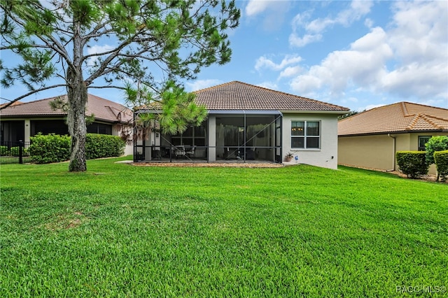 rear view of property with a yard