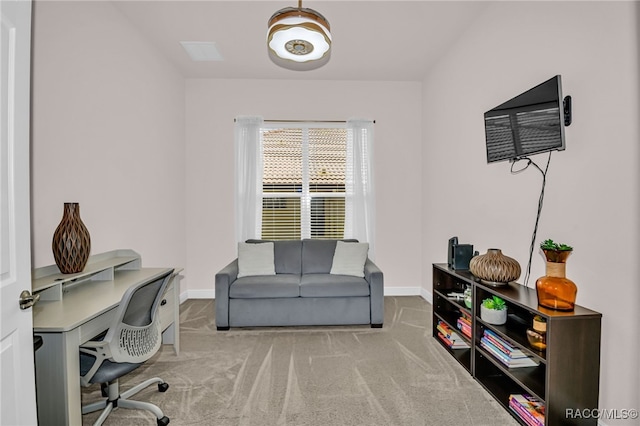 carpeted home office featuring baseboards