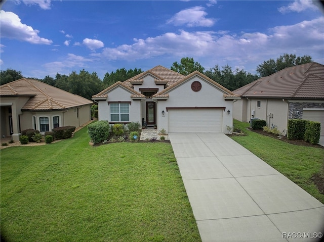 view of front facade featuring a tile roof, stucco siding, a front yard, a garage, and driveway