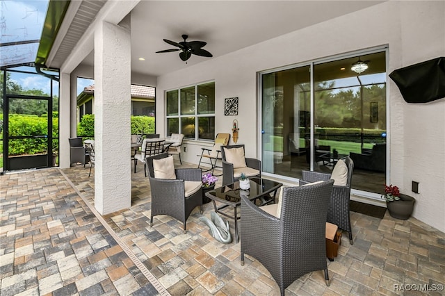 view of patio / terrace featuring glass enclosure and ceiling fan