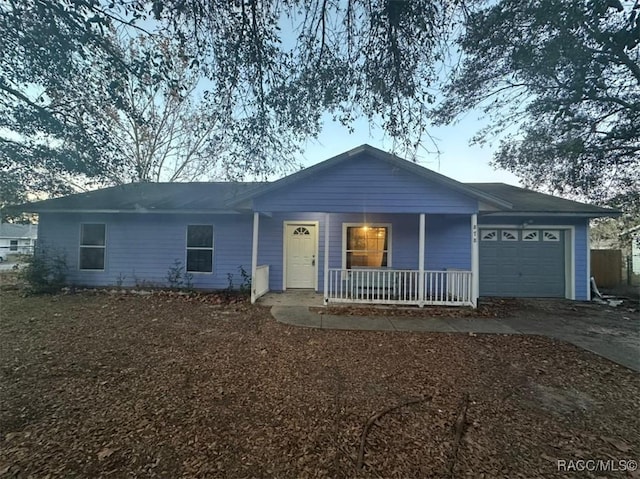 single story home featuring a porch and a garage