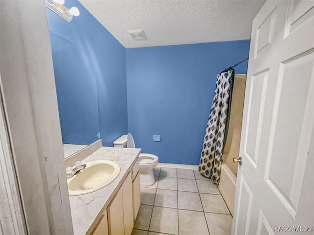 full bathroom with vanity, tile patterned flooring, toilet, shower / bath combo with shower curtain, and a textured ceiling