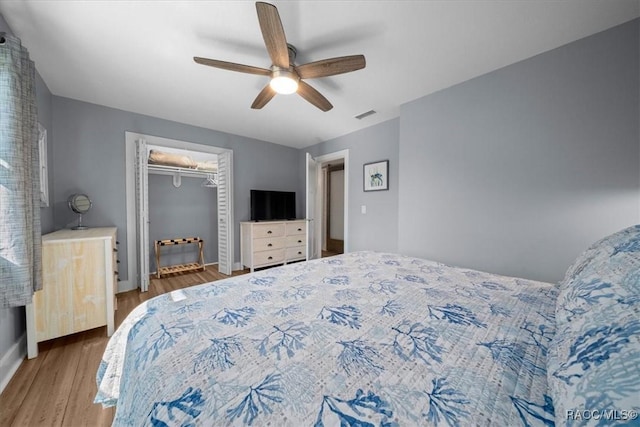 12046 W Gulf Breeze Ct, Crystal River, FL 34429 - bedroom featuring wood finished floors, a ceiling fan, and a closet