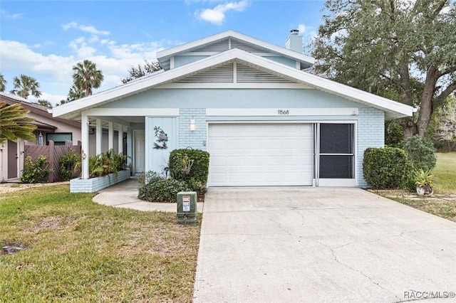 view of front of home with a front yard and a garage