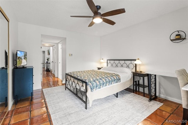 tiled bedroom with ceiling fan