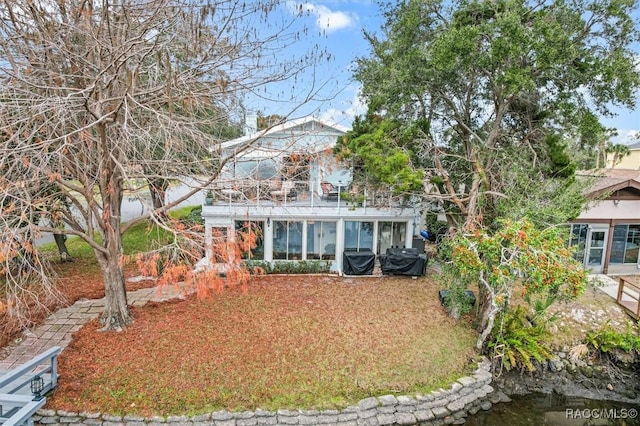 view of front of property with a sunroom and a water view