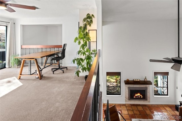 balcony with ceiling fan and a fireplace