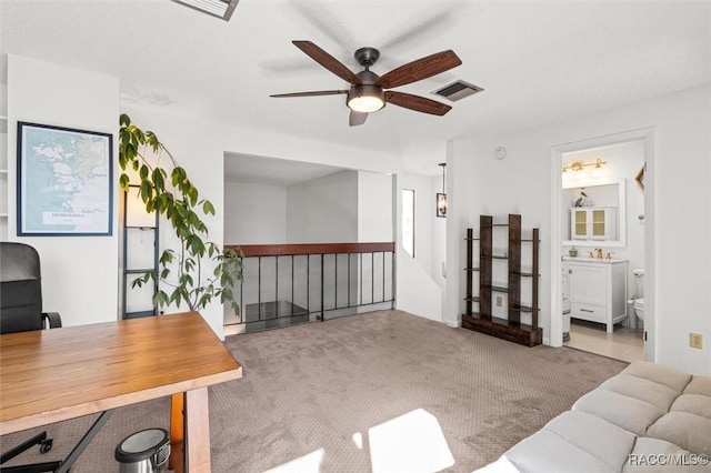 office space with ceiling fan and light colored carpet