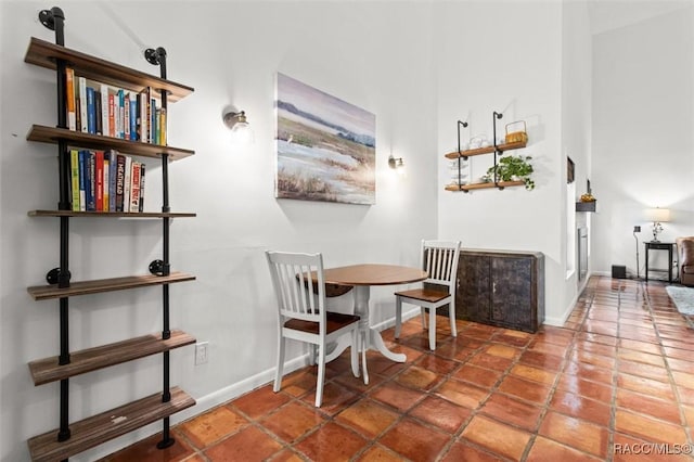 dining room featuring dark tile patterned flooring