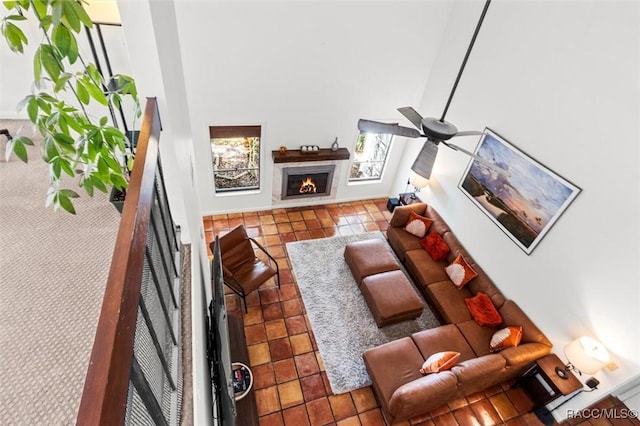 living room with ceiling fan and tile patterned floors