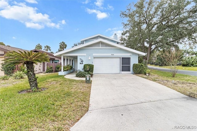 view of front of home with a front yard and a garage