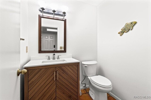 bathroom featuring toilet and vanity