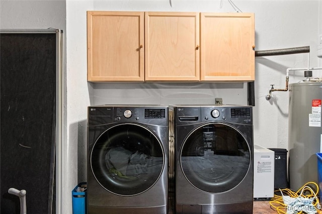 laundry room featuring cabinets, separate washer and dryer, and water heater